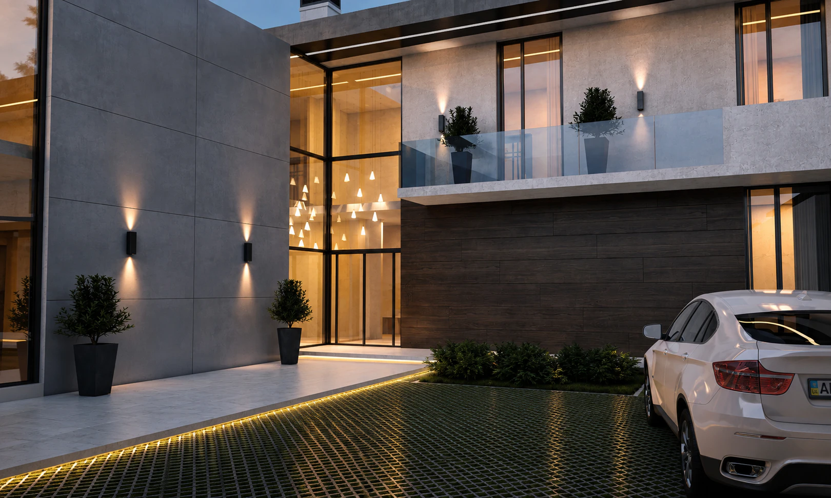 Evening entrance court with balcony, illuminated glazing, and planted paving